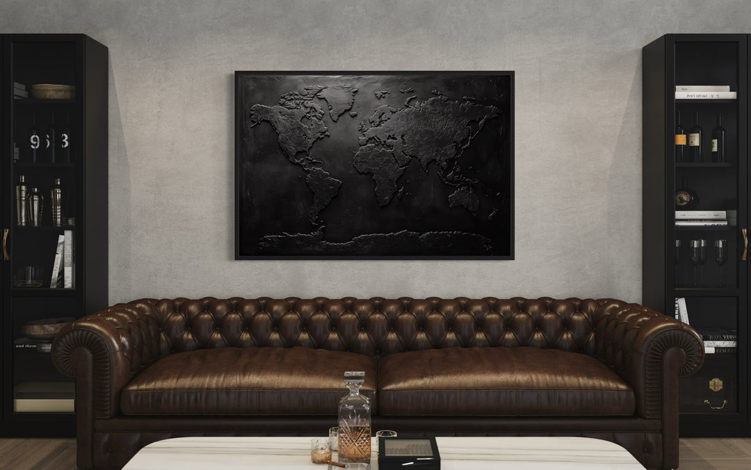 Black World Map Framed Canvas Wall Art in a living room with a couch and a table