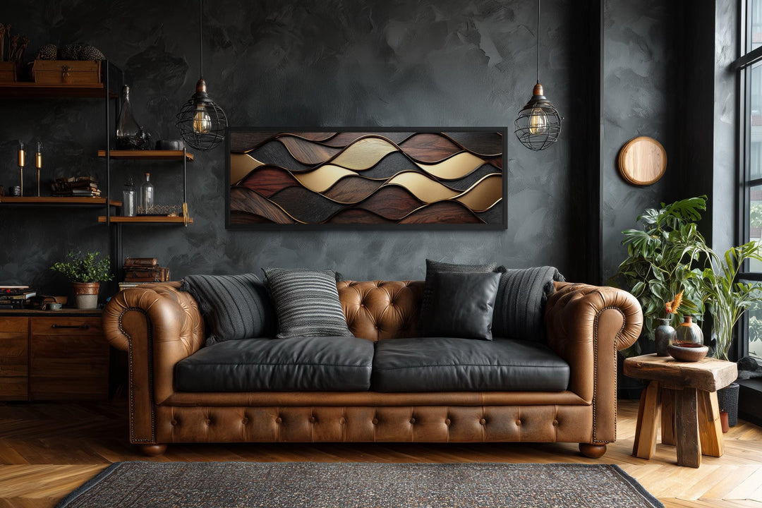 Long horizontal abstract canvas with brown and gold geometric wood texture waves above a sofa.