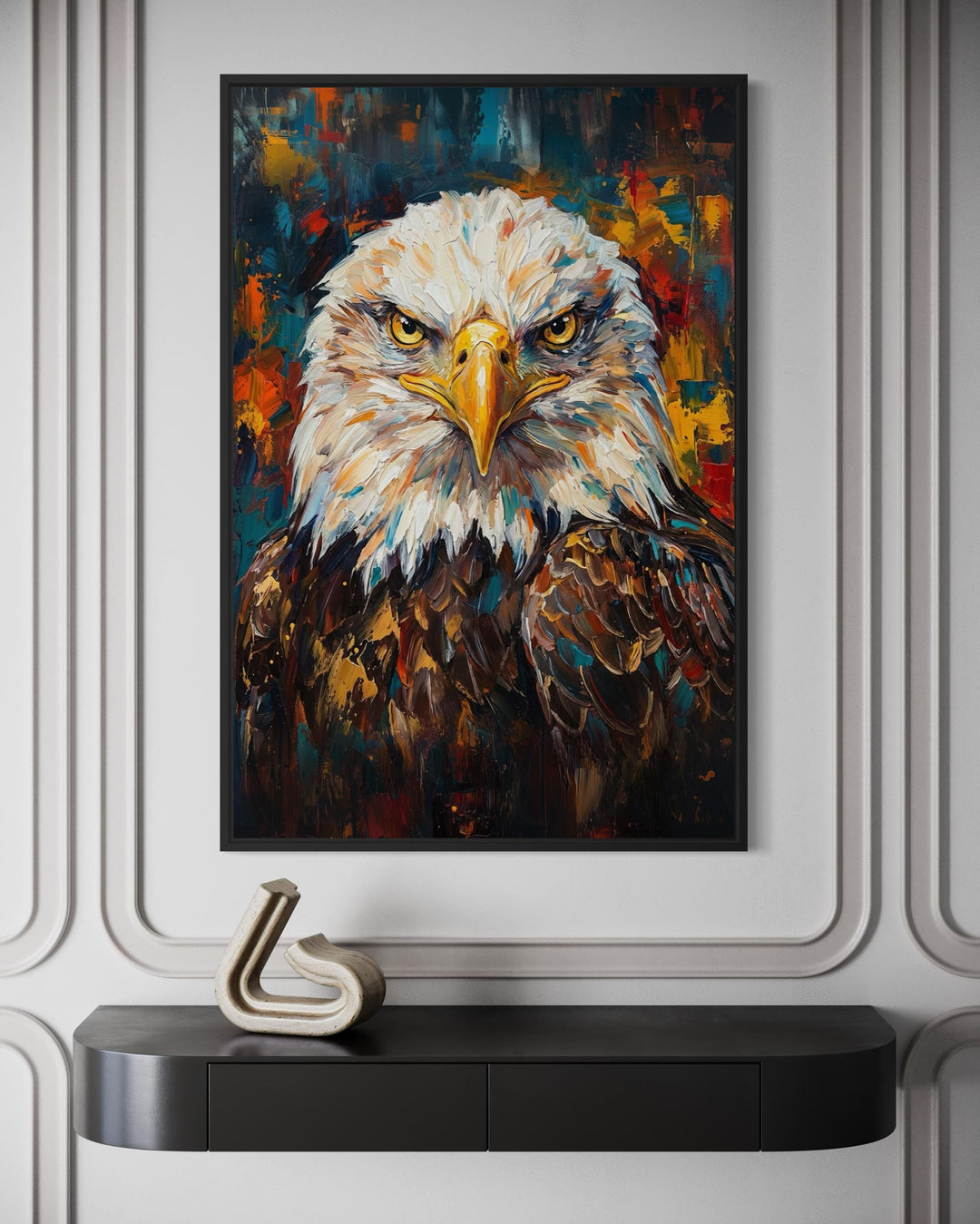 Abstract bald eagle portrait canvas wall art in a black frame above a modern console table.