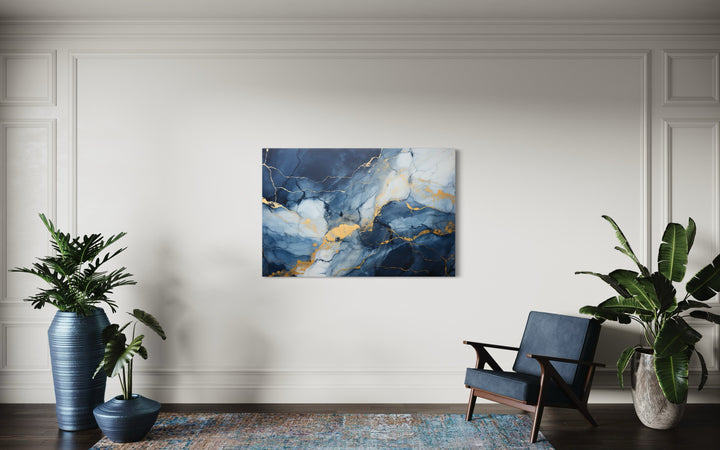 Navy Blue Grey Gold Abstract Marble Canvas Wall Art in a living room with a blue chair