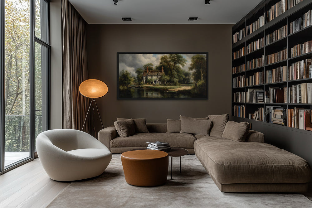 a modern living room with a large window overlooking a scenic view, a comfortable sofa, a round coffee table, and a bookshelf filled with books.