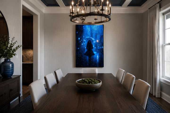 Vertical canvas wall art of a woman's silhouette in blue rain, hung in a modern dining room.