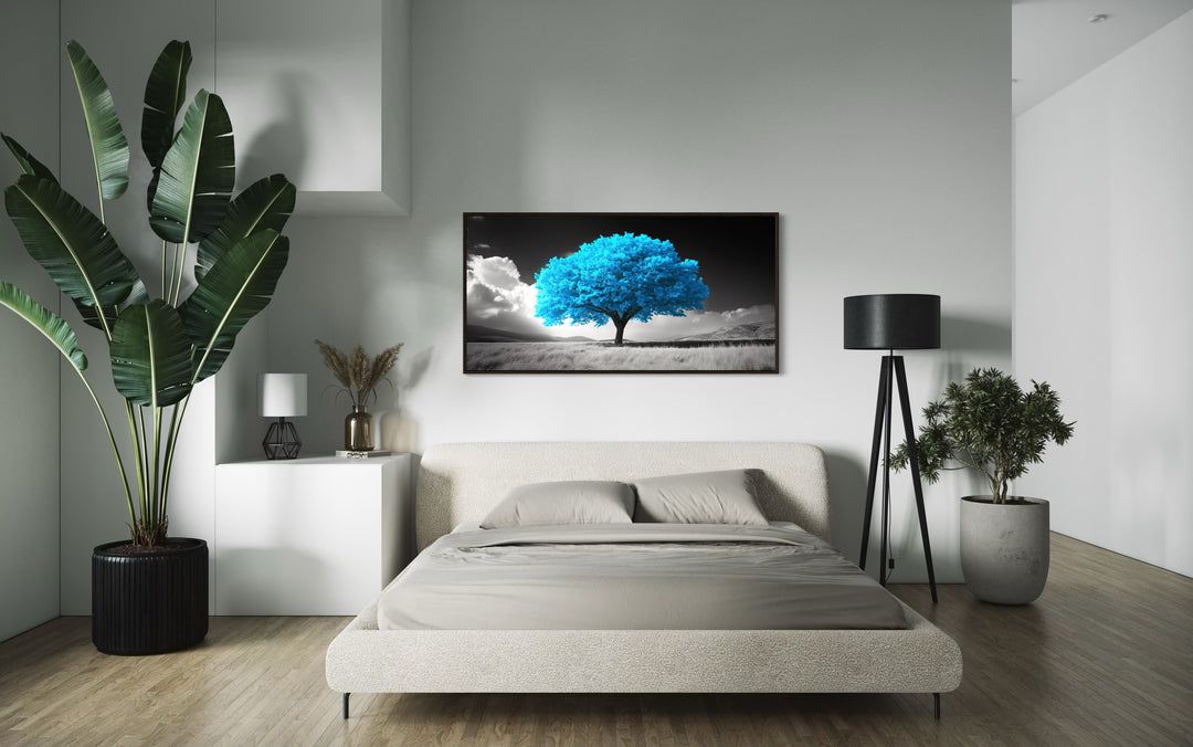 Blue Tree on Black White Background Framed Canvas Wall Art in a bedroom with a bed and a painting on the wall