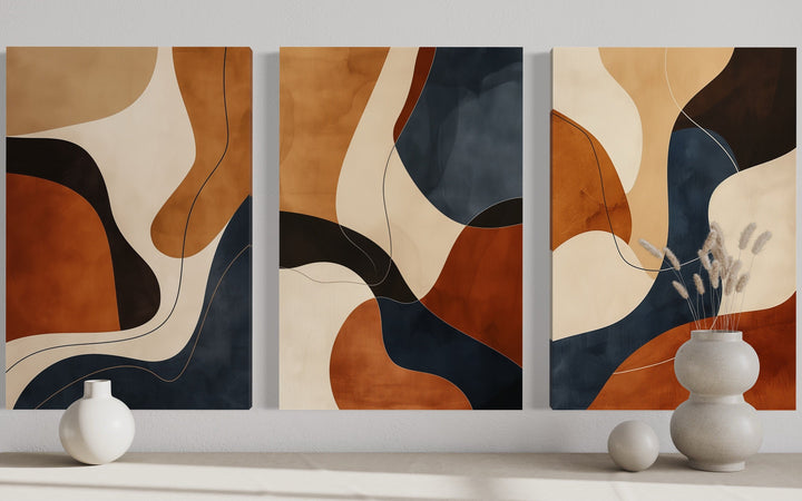 3-piece abstract wall art set with mid-century modern shapes in brown, cream, and navy earth tones.