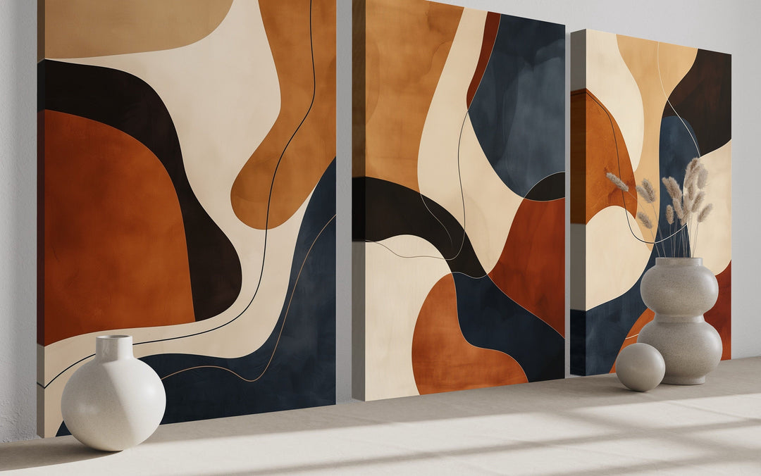 3 piece mid-century modern abstract wall art in earth tones, brown, cream, and navy blue.