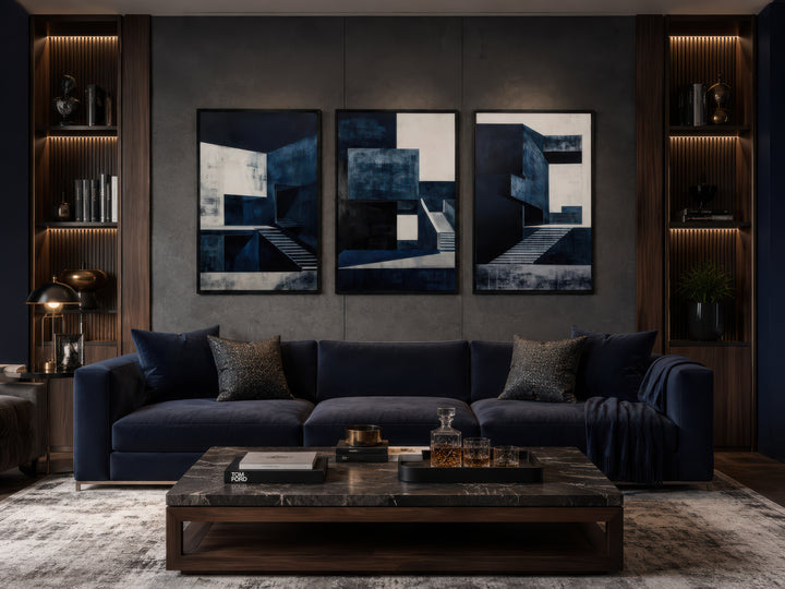3 piece mid century modern navy blue architectural wall art set above a dark blue velvet sofa.