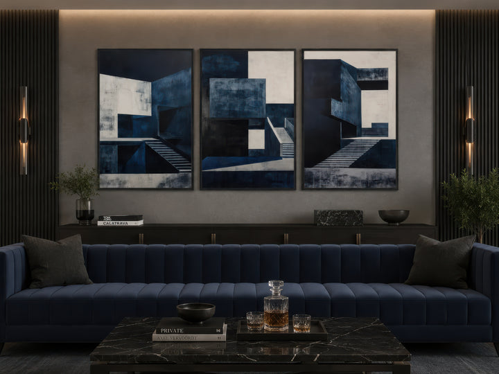 3 piece mid-century modern navy blue architectural wall art set above a blue sofa.