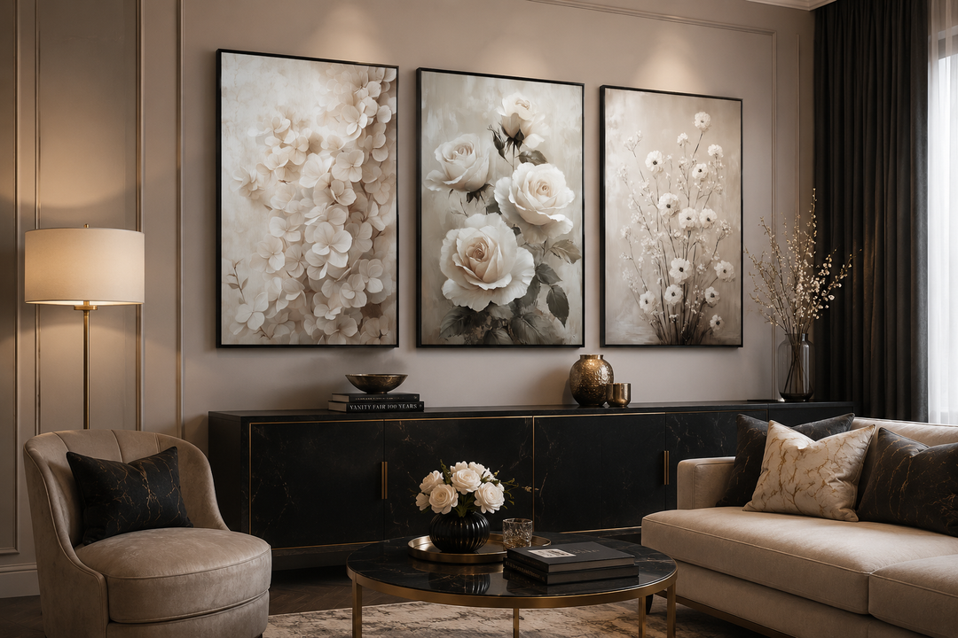 Set of 3 framed canvas wall art featuring neutral beige floral paintings above a black sideboard.