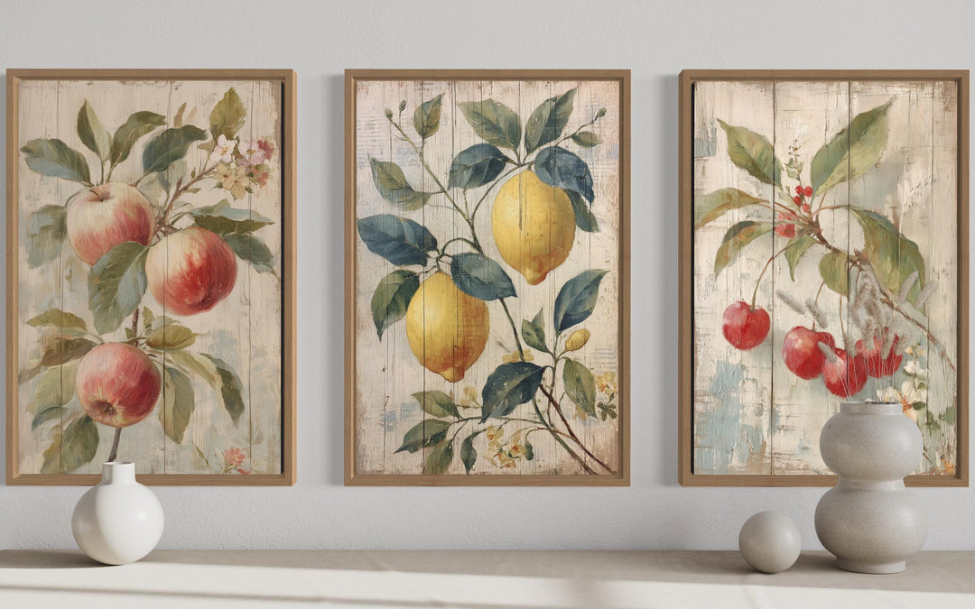 3-piece rustic fruit wall art set featuring vintage-style apple, lemon, and cherry illustrations.