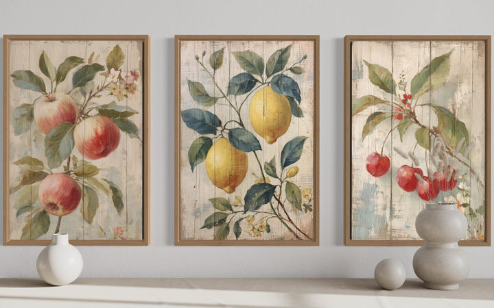 3-piece rustic fruit wall art set featuring vintage-style apple, lemon, and cherry illustrations.