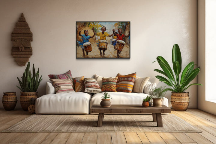 Happy African Kids Playing Drums Framed Canvas Wall Art in a living room filled with furniture and a painting on the wall