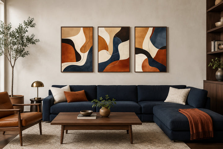 3-piece mid-century modern abstract wall art set in earth tones, brown, cream, and navy blue frames.