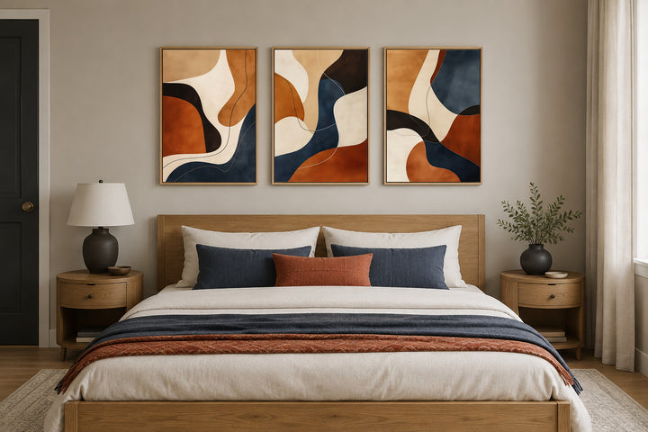 3 piece mid-century modern abstract wall art in earth tones, brown, cream, and navy, framed.