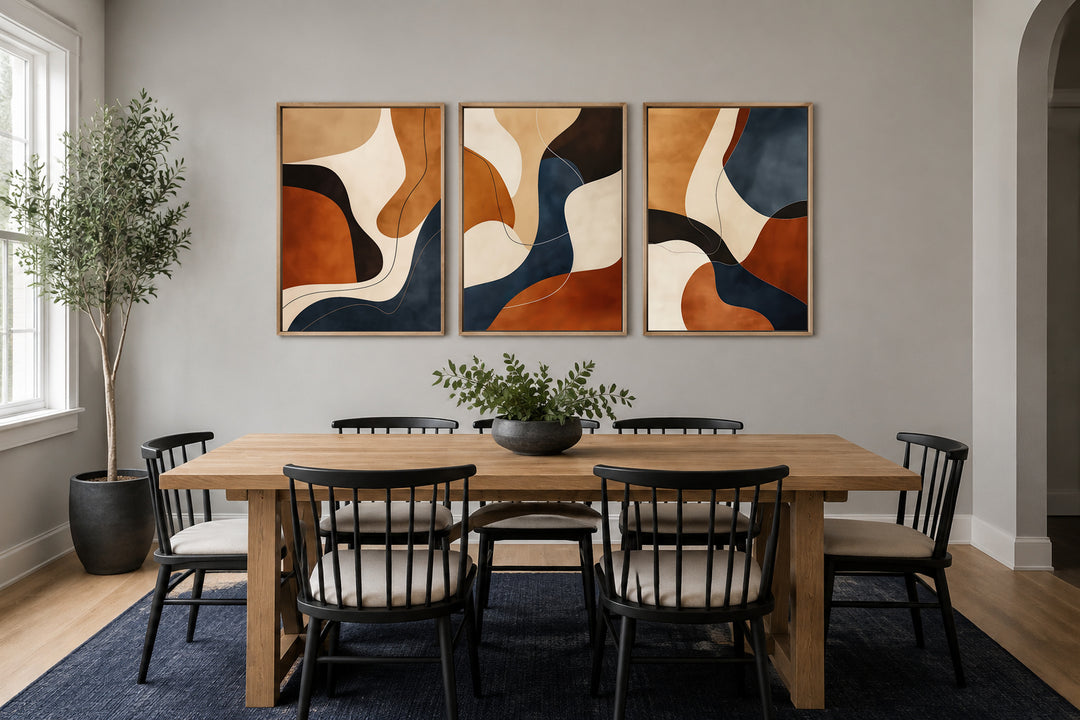 3 piece mid-century modern abstract wall art in earth tones, brown, cream, and navy, framed.