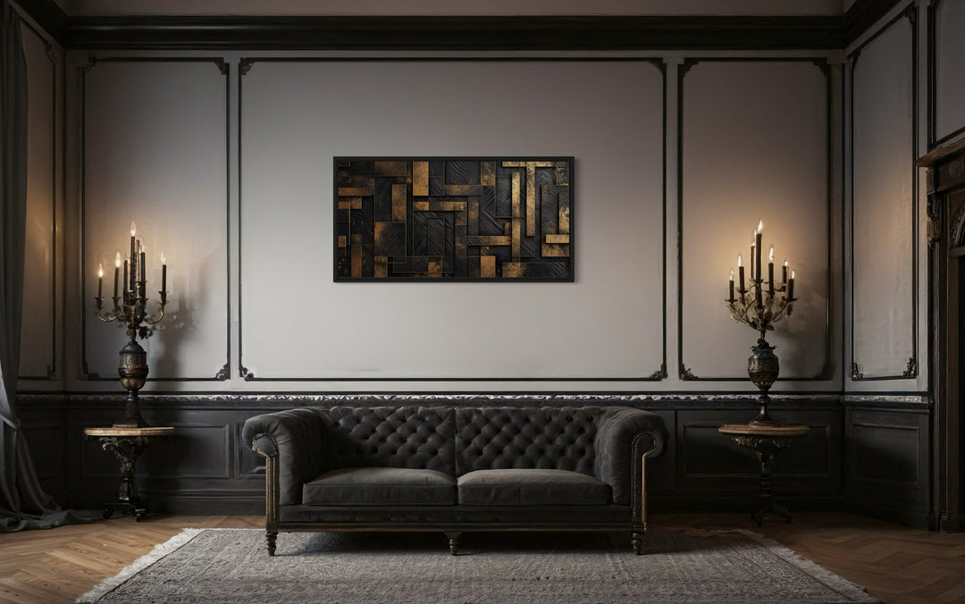 Black Gold Abstract Geometric Framed Canvas Wall Art in a living room with a couch and a chandelier