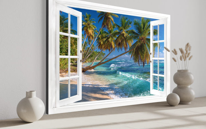 Canvas wall art of a white open window overlooking a tropical beach with palm trees and blue ocean.