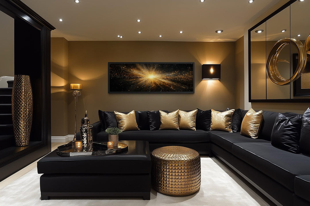 Horizontal black and gold starburst canvas wall art centered above a modern black sectional sofa.