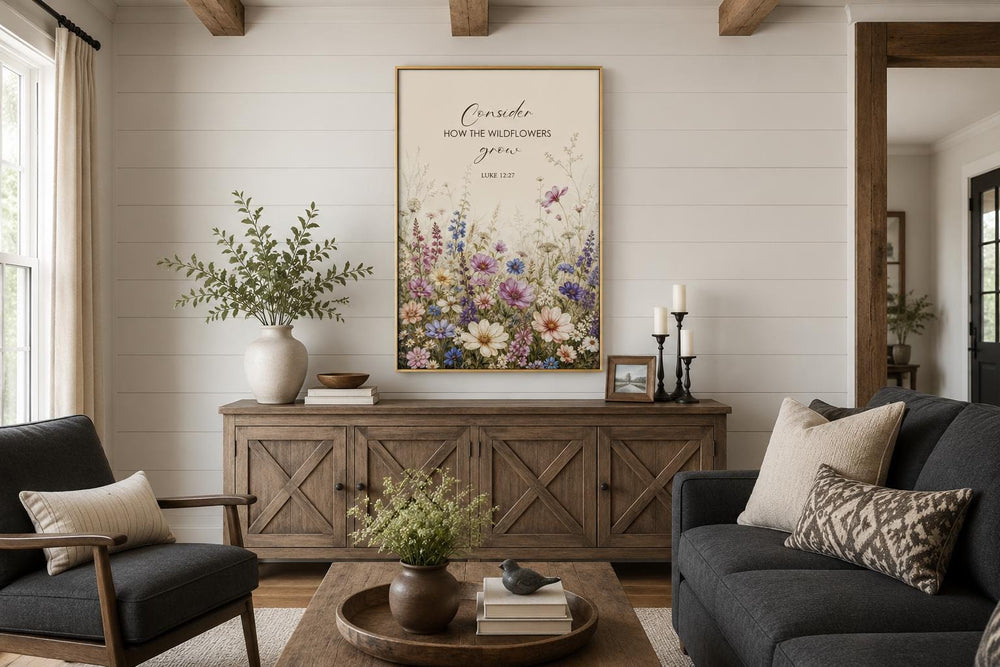 Wildflower watercolor wall art with Luke 12:27 scripture verse in a gold frame above a sideboard.
