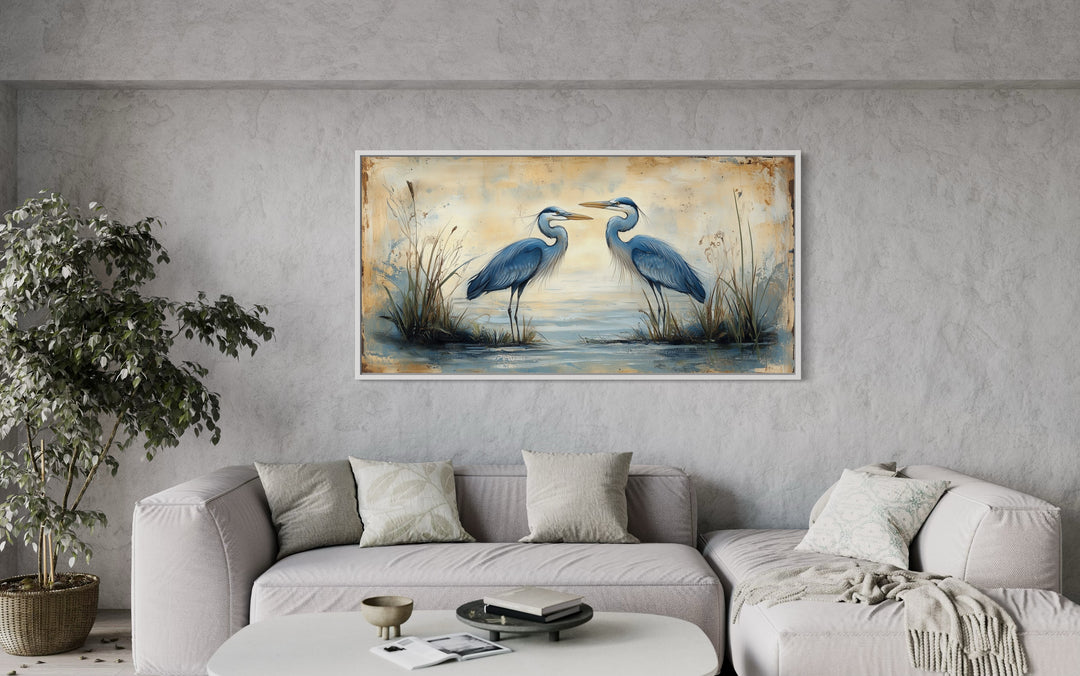 Rustic Blue Herons Horizontal Framed Canvas Wall Art in a living room with a couch