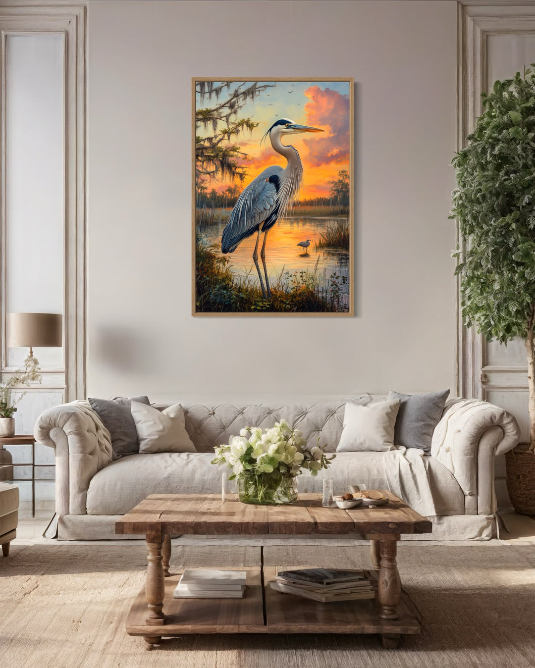 Blue Heron at Sunset Marshland Framed Canvas Wall Art in a living room with a couch a table