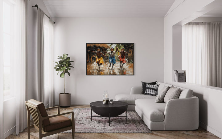 Happy African Boys Dancing In Rain Framed Canvas Wall Art in a living room filled with furniture