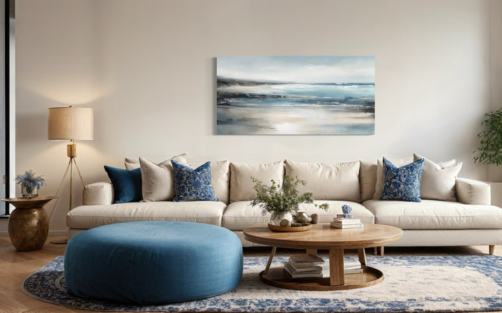 Calm Minimalist Blue Gray Ocean Coastal Framed Canvas Wall in a living room filled with furniture