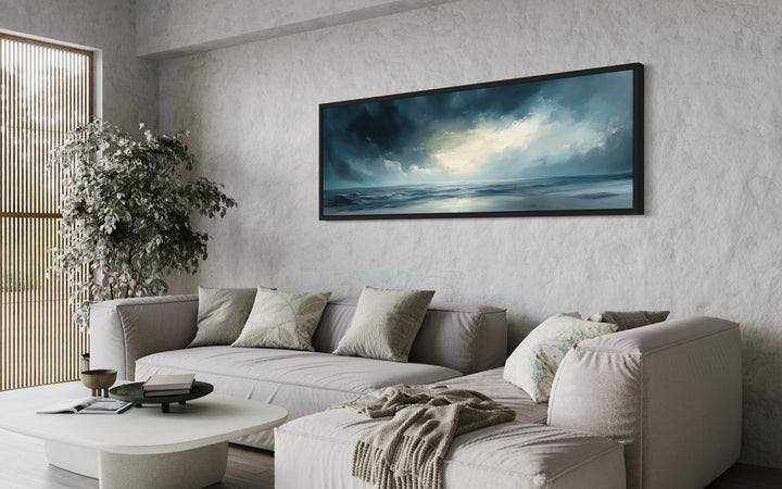 Stormy Horizon Over The Ocean Panoramic Canvas Wall Art in a living room with a couch and a coffee table