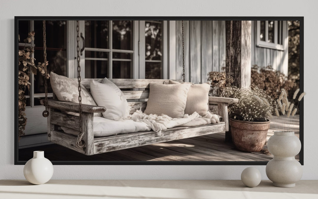 a picture of a porch swing with pillows on it