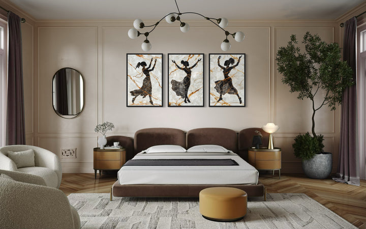 a bedroom with a bed, chair, mirror and two pictures on the wall