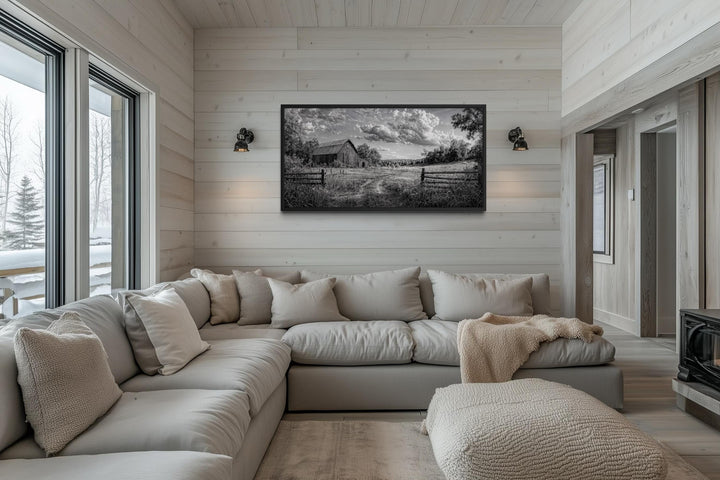 Black and white barn landscape canvas wall art hanging in a rustic farmhouse living room.