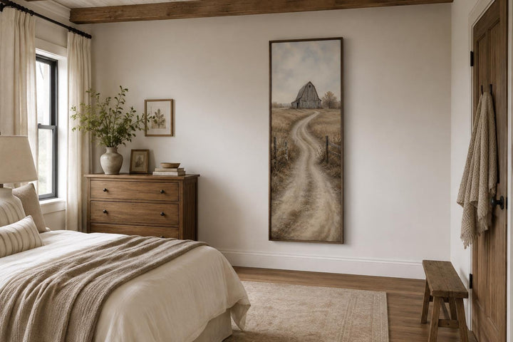 Tall narrow farmhouse wall art of a weathered barn on a winding road through golden fields.