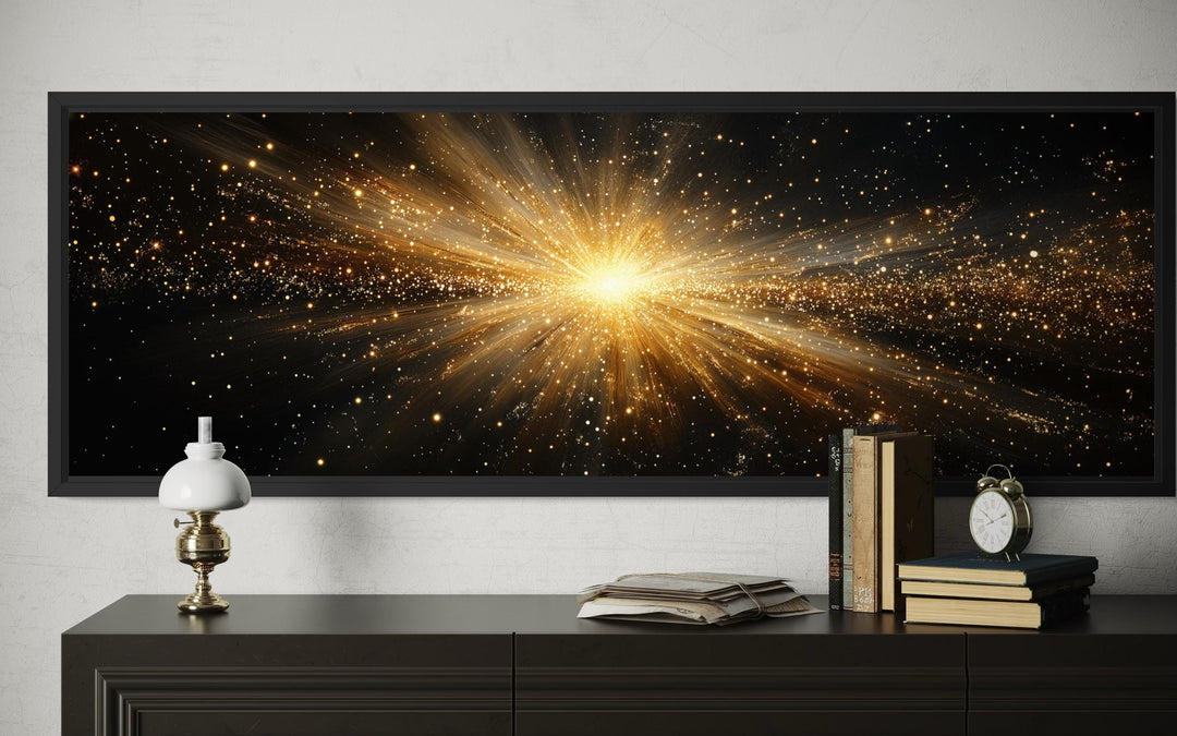 A wide horizontal canvas print of a radiant gold starburst explosion on a black background.