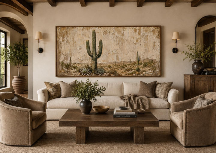 Minimalist saguaro cactus painting on weathered wood background canvas art in a neutral living room.
