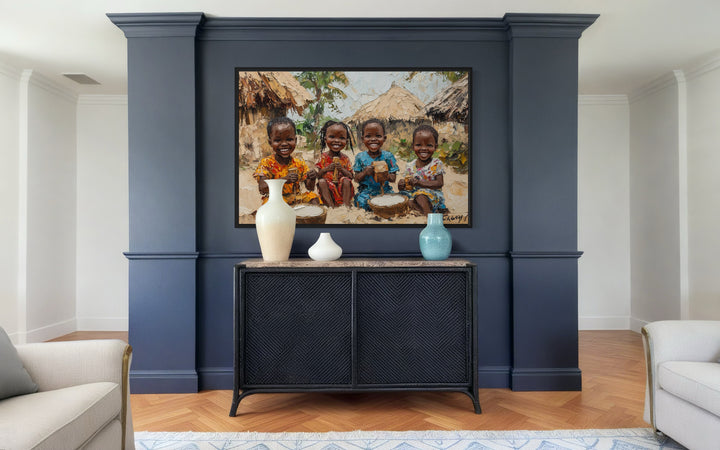 Happy African Children Playing In The Village Framed Canvas Wall Art in a living room with a painting on the wall