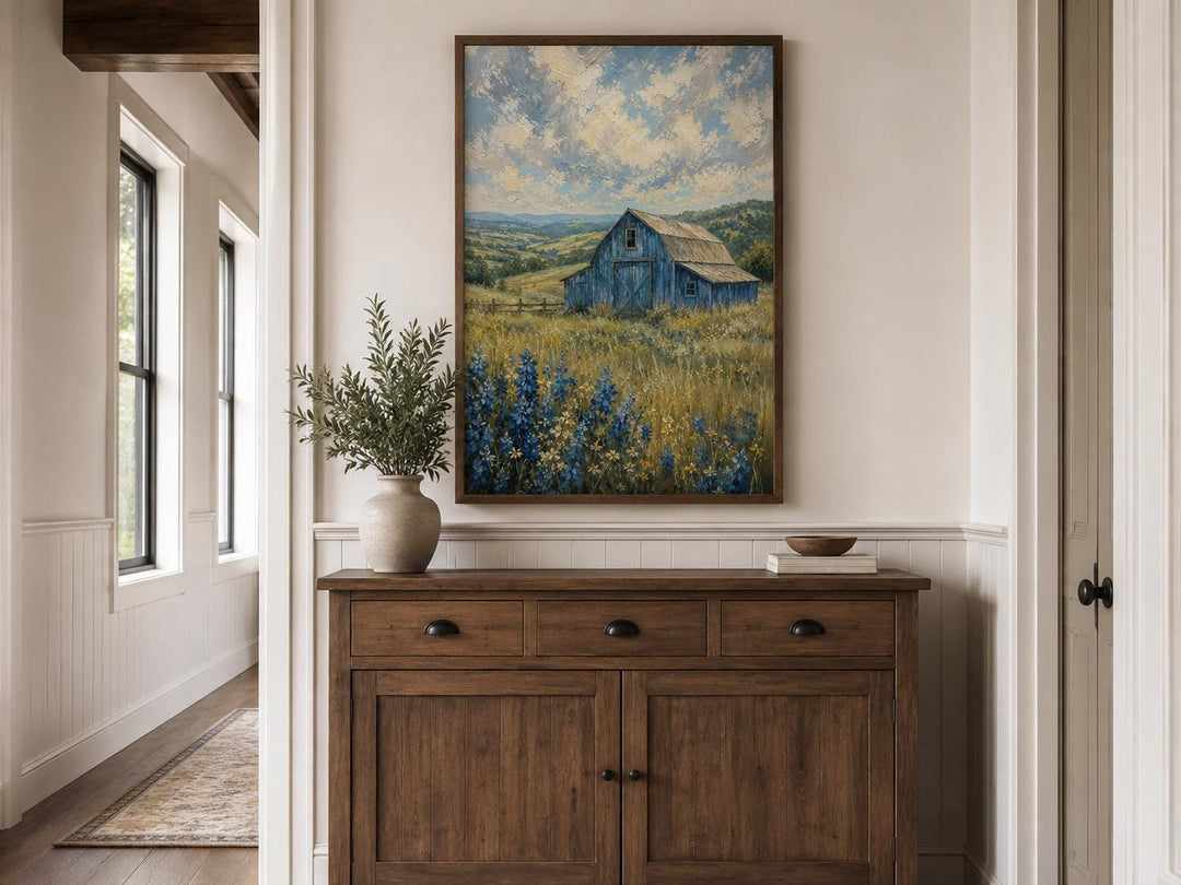 Vertical farmhouse canvas art of a blue barn in a bluebonnet field under a cloudy sky.