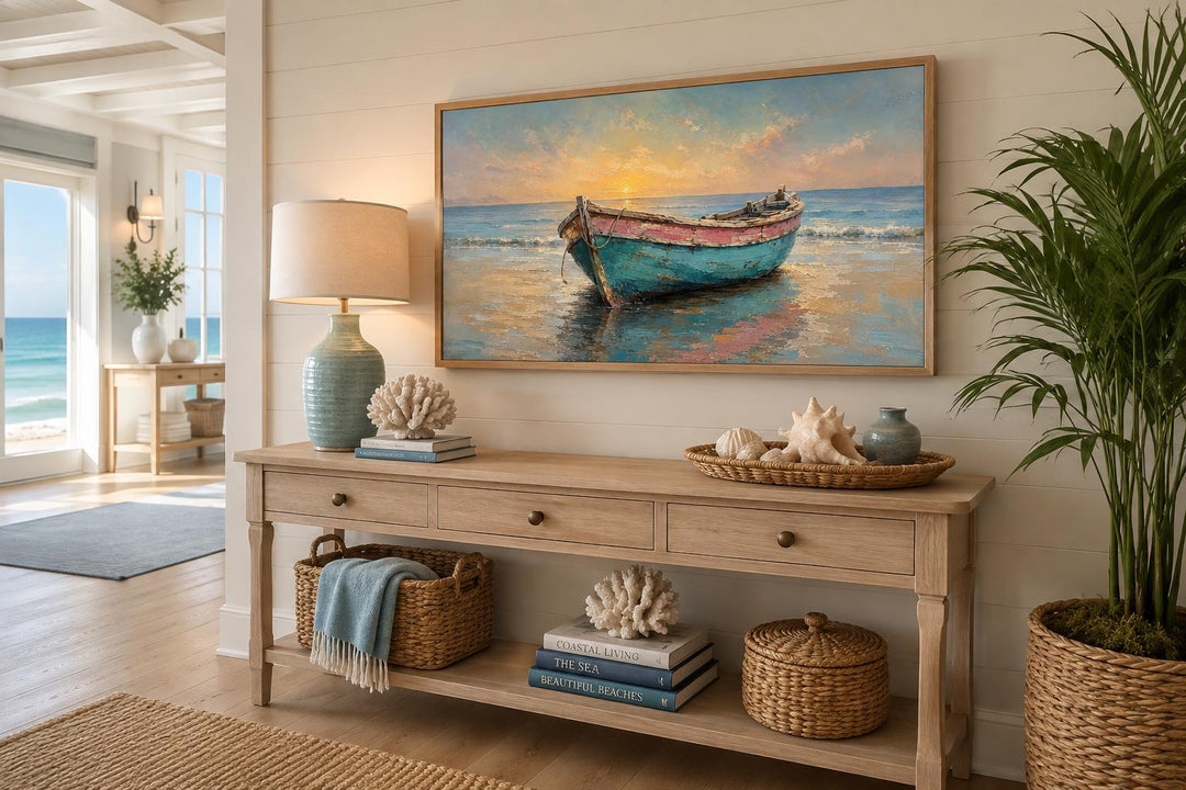 Weathered teal and pink rowboat painting in a gold frame above a wooden console table.