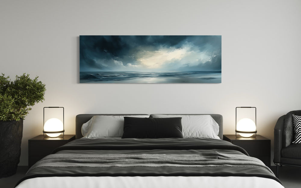 Stormy Horizon Over The Ocean Panoramic Canvas Wall Art above man's bed