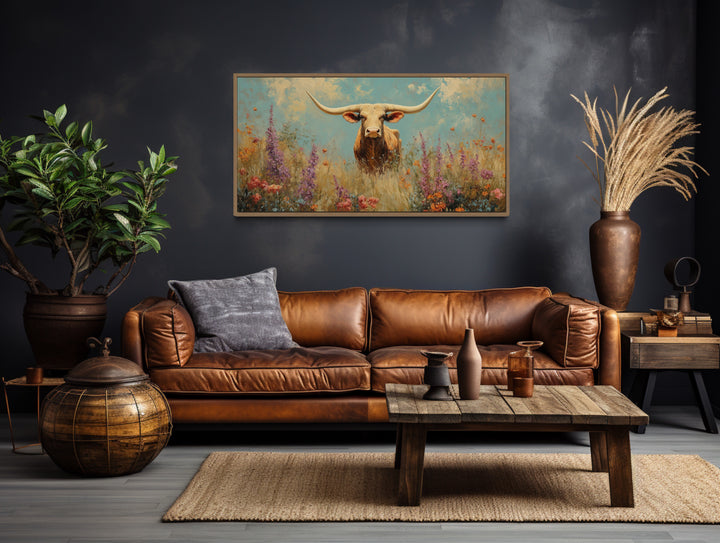 Longhorn in Wildflower Field Rustic Farmhouse Canvas Wall Art above brown couch