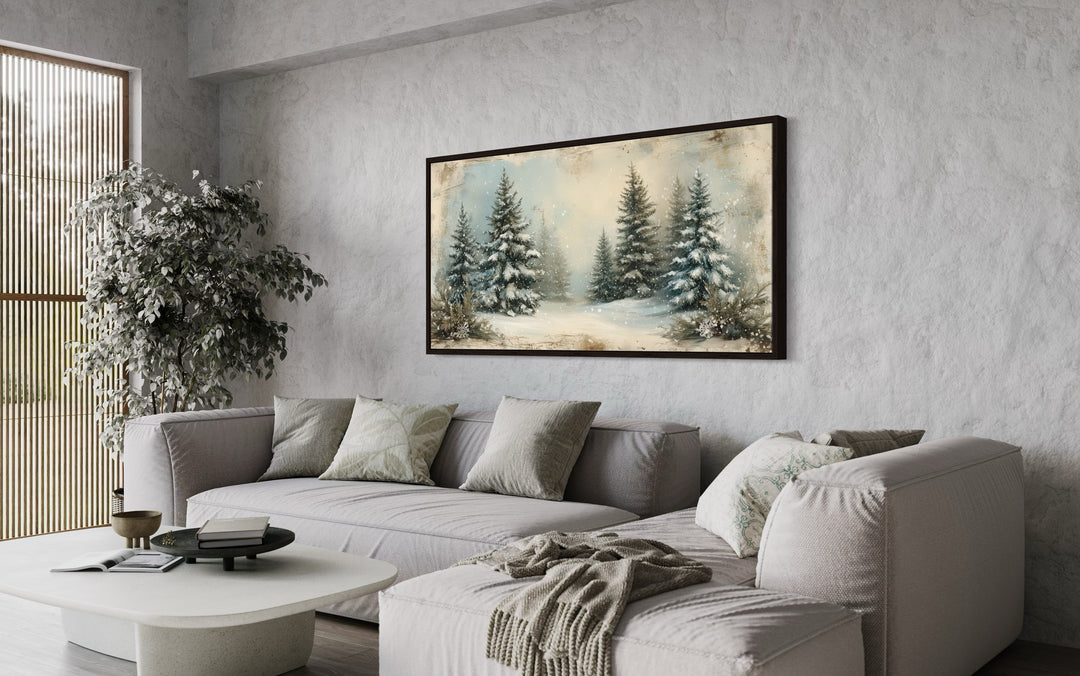 a living room with a white couch and a painting on the wall