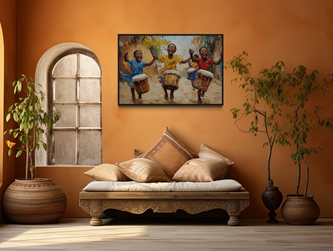 Happy African Kids Playing Drums Framed Canvas Wall Art in a living room with a couch and a painting on the wall