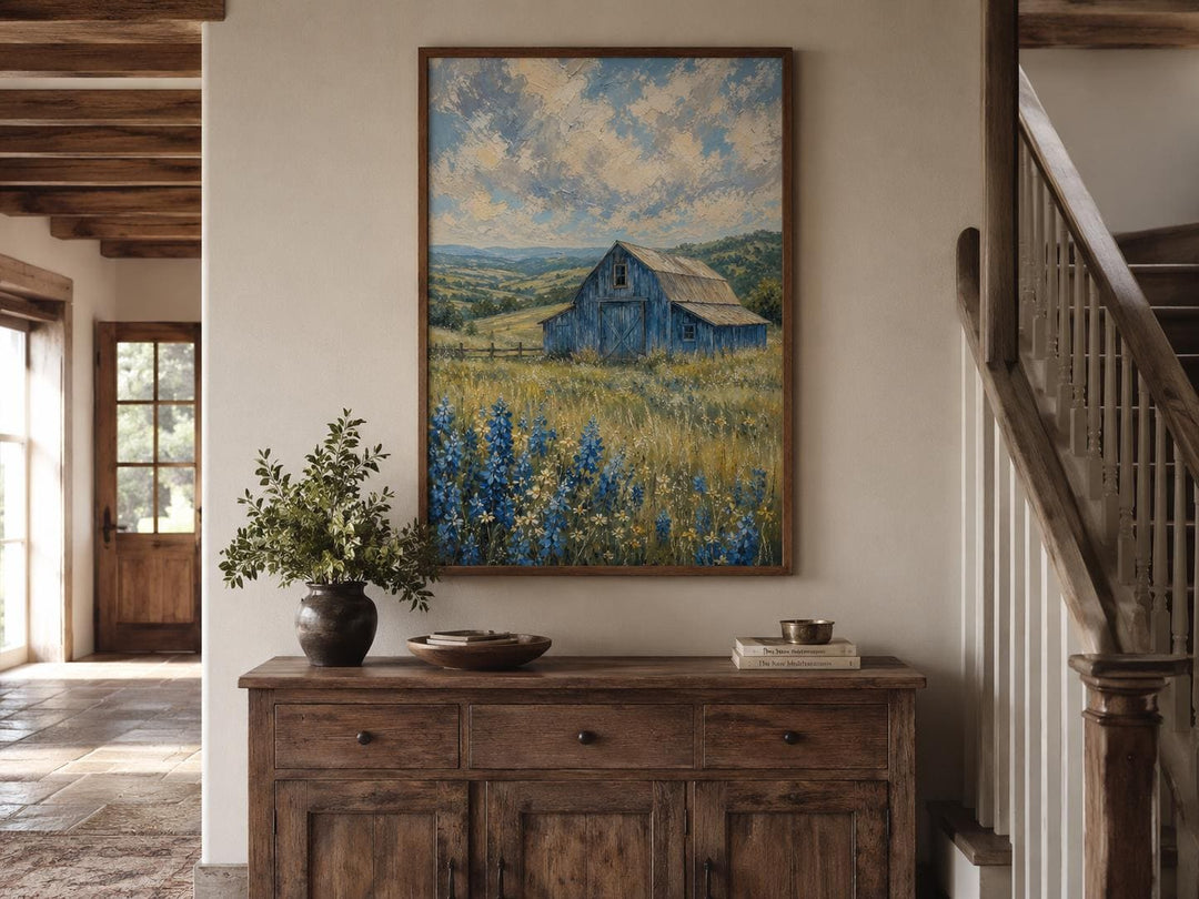 Vertical farmhouse canvas art of a blue barn in a bluebonnet field under a cloudy sky.