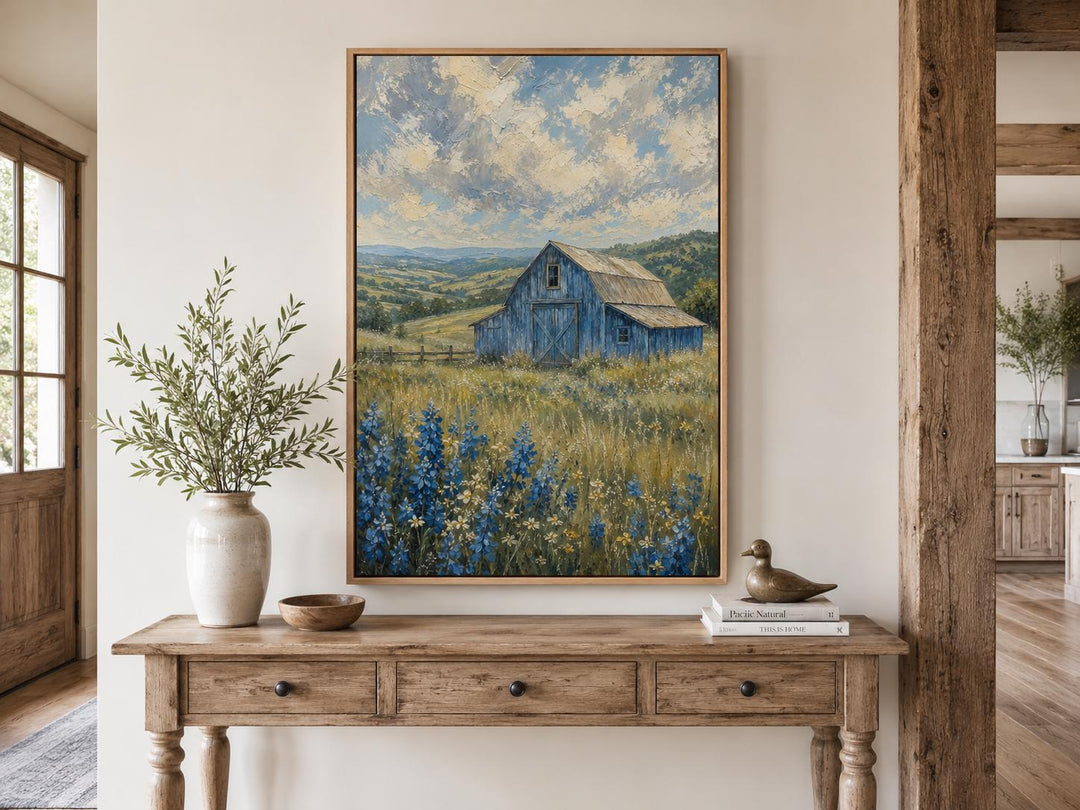 Vertical farmhouse canvas art of a blue barn in a bluebonnet field under a cloudy sky.