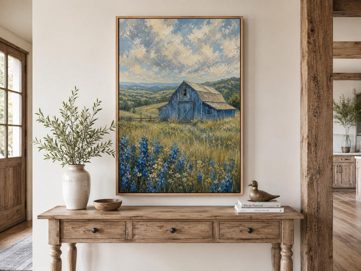 Vertical farmhouse canvas art of a blue barn in a bluebonnet field under a cloudy sky.