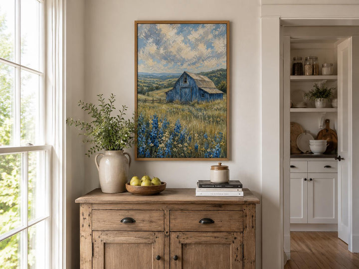 Vertical farmhouse canvas art of a blue barn in a field of bluebonnets under a cloudy sky.