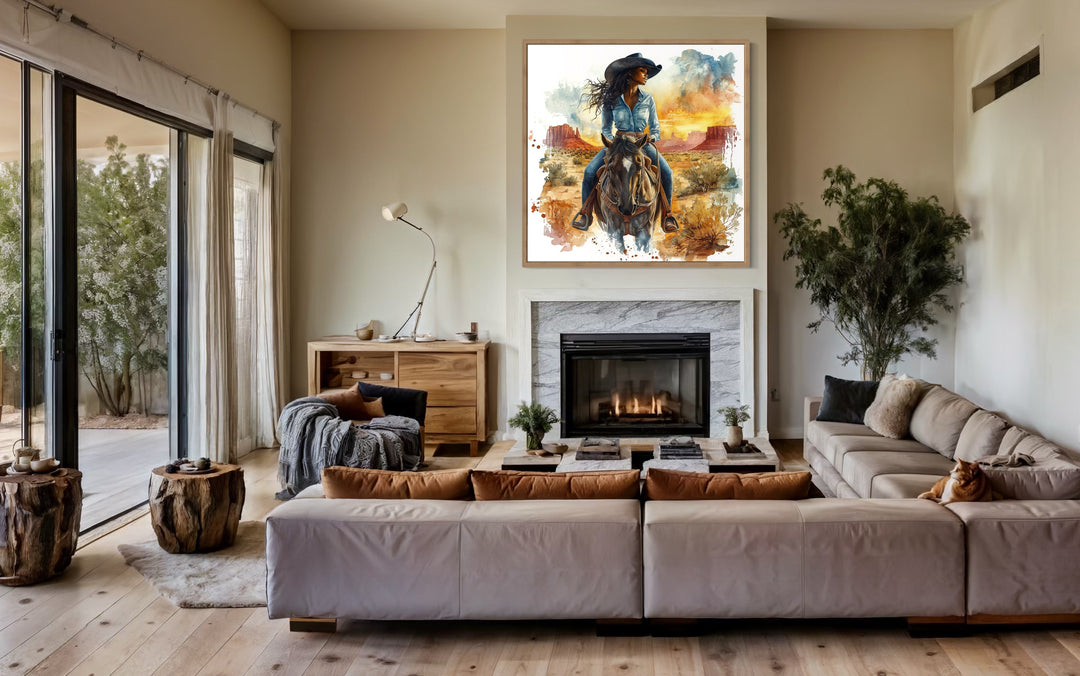 African American Cowgirl Riding A Horse Framed Canvas Wall above fireplace