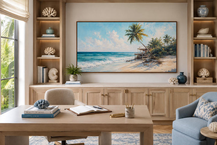 Tropical beach wall art with palm trees and turquoise waves in a bright coastal home office.