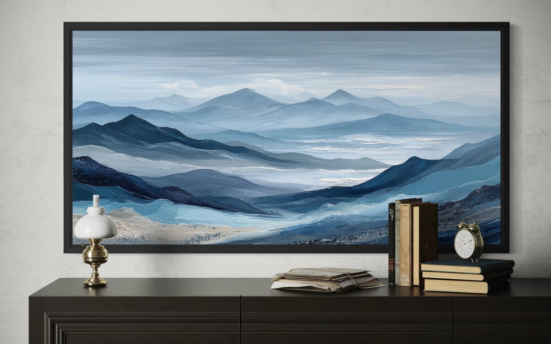 Blue Mountain Serene Nature Landscape Canvas Wall Art in a black frame above a dark console table.