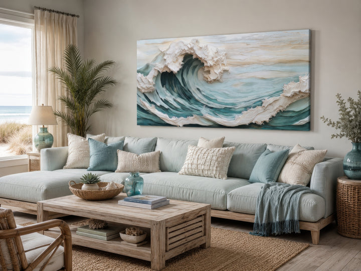 Abstract 3D effect teal ocean wave framed canvas wall art hanging above a light blue sofa.