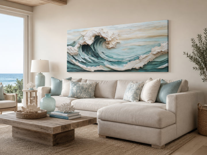 Abstract 3D effect teal ocean wave framed canvas wall art above a neutral sectional sofa.