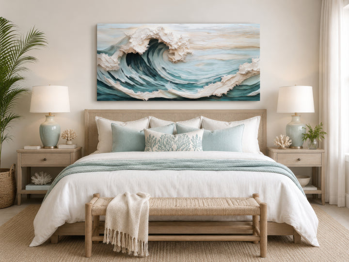 Abstract 3D effect teal ocean wave framed canvas wall art hanging above a bed in a coastal bedroom.